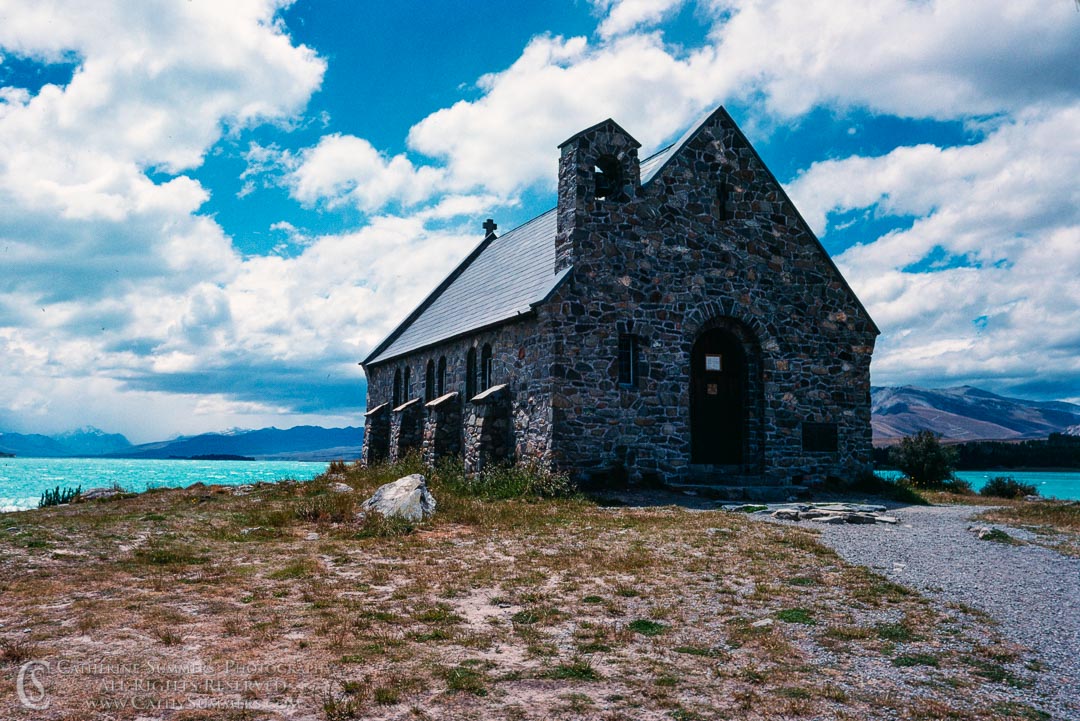1988_NZ_005: clouds, horizontal, church, lake, mountains, New Zealand, South Island, sone