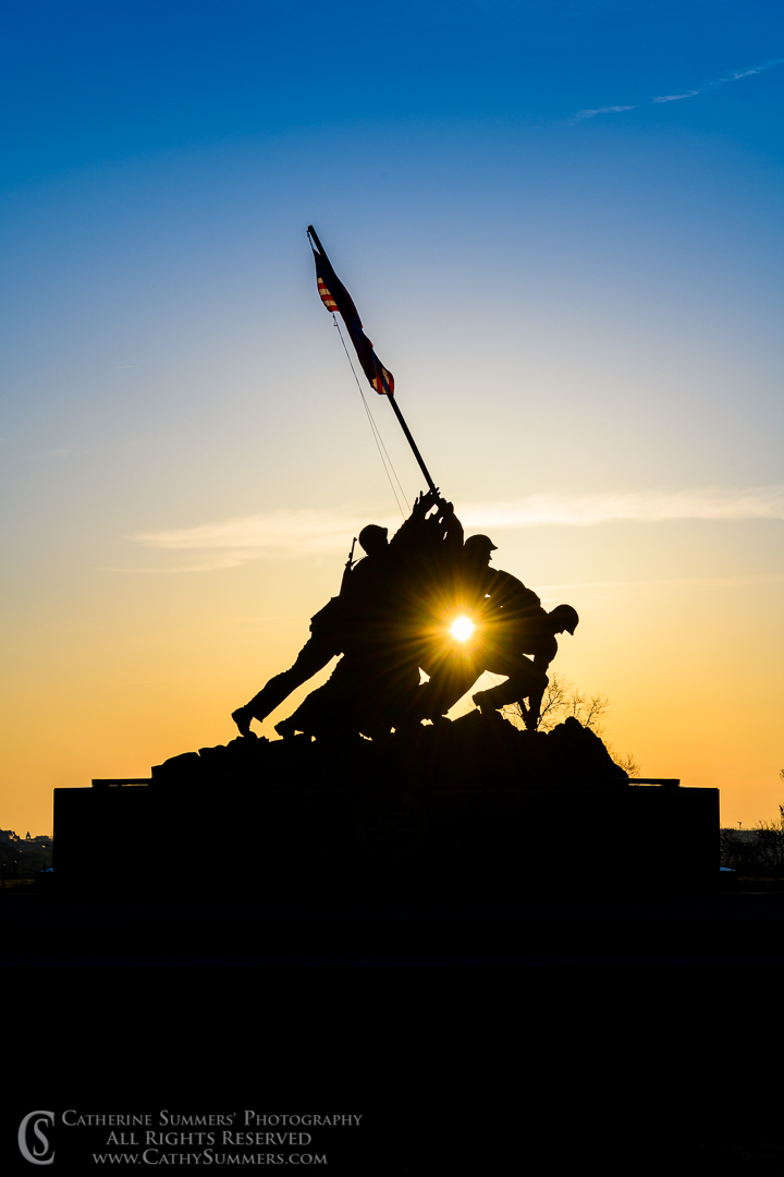 Sunburst Through the Raising the Flag Sculpture at the USMC War Memorial on a Spring Morning
