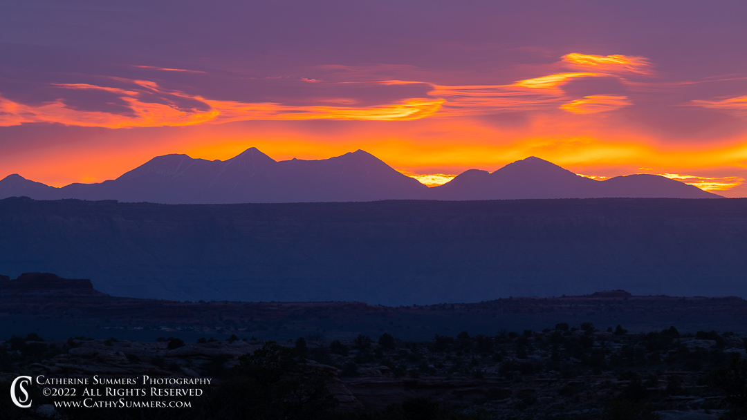 Fiery Sunrise behind the La Sal Mountains and Colorado River Canyon Walls in Canyonlands National Park Needles District